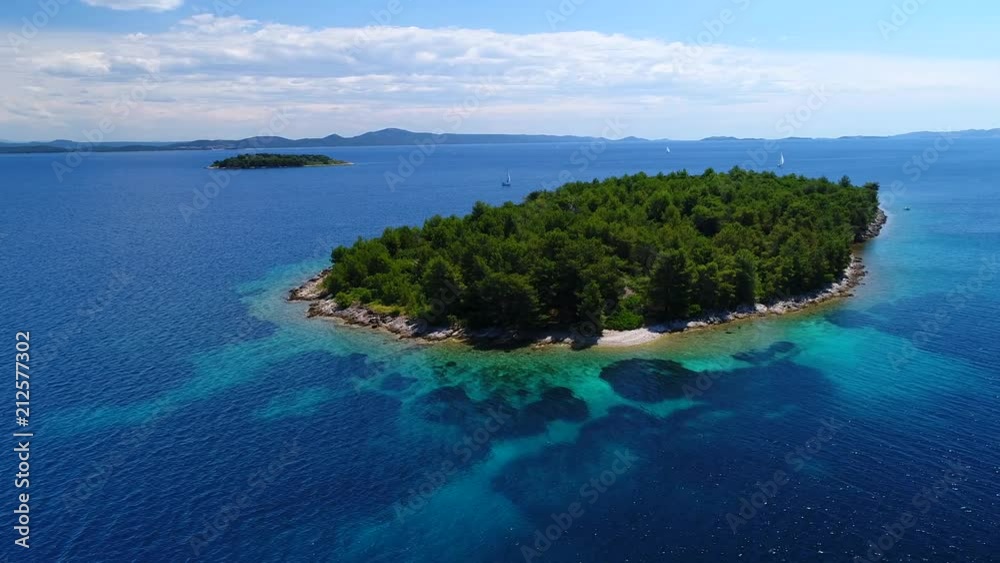 Aerial shot of a small green island and blue clear sea. Aerial shot of a small green island and blue clear sea.
