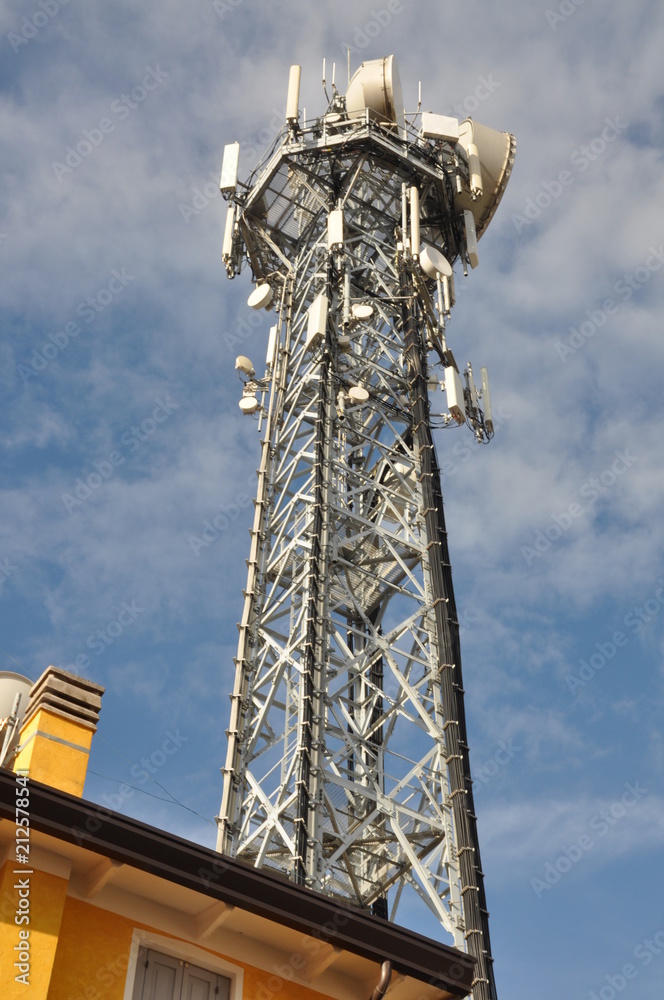 Obraz premium Telecommunication tower with antennas over the top of a building