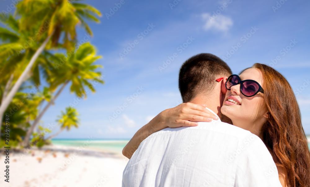 travel, tourism and summer vacation concept - happy couple hugging over tropical beach background in french polynesia travel, tourism and summer vacation concept - happy couple hugging over tropical beach background in french polynesia