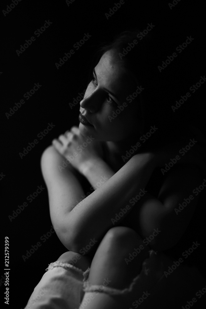 Studio portrait of a beautiful brunette on a black background Studio portrait of a beautiful brunette on a black background