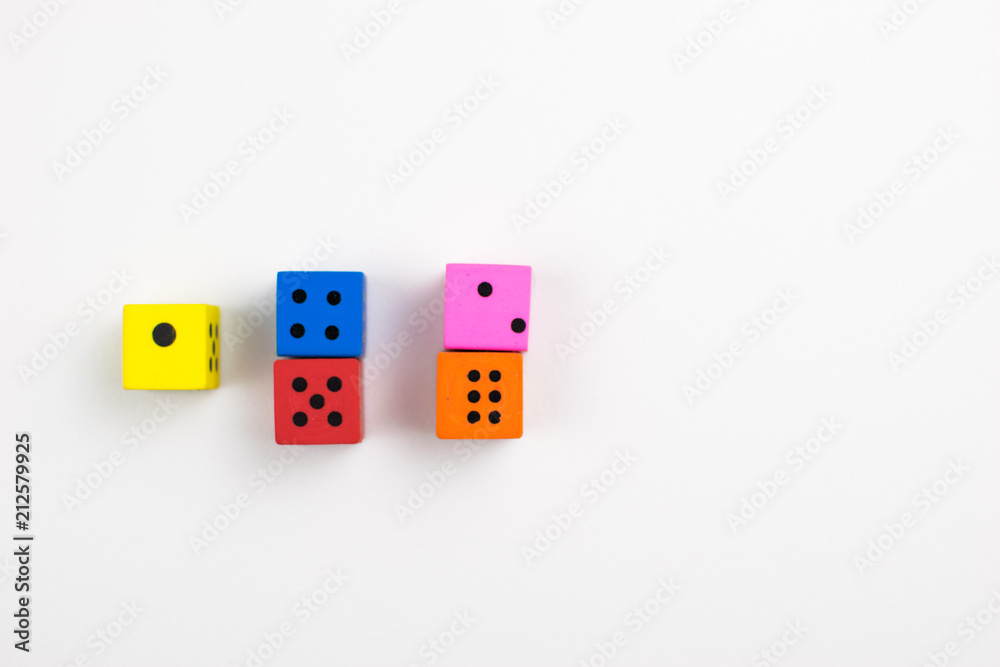 Multicolored dice cubes on a light background. Multicolored dice cubes on a light background.