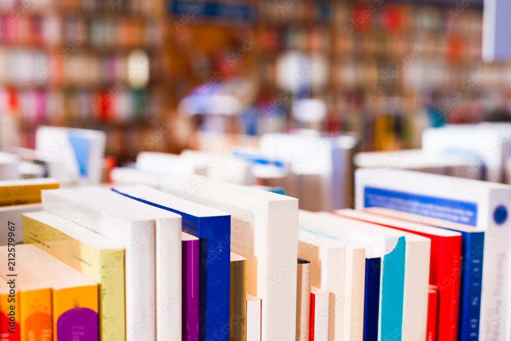 Naklejka premium stack of books lying on table in bookstore