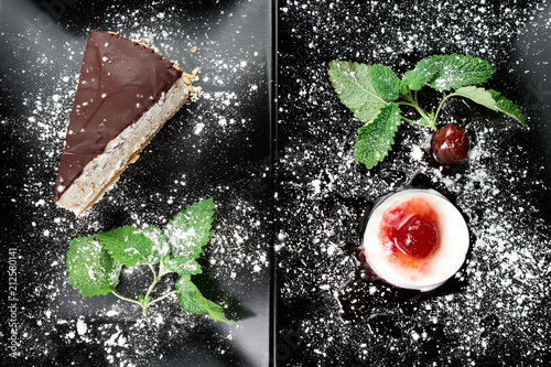 Photo of italian panna cotta dessert with strawberry sirup and cake with nuts and chocolate on the black plate on dark wooden background. photo
