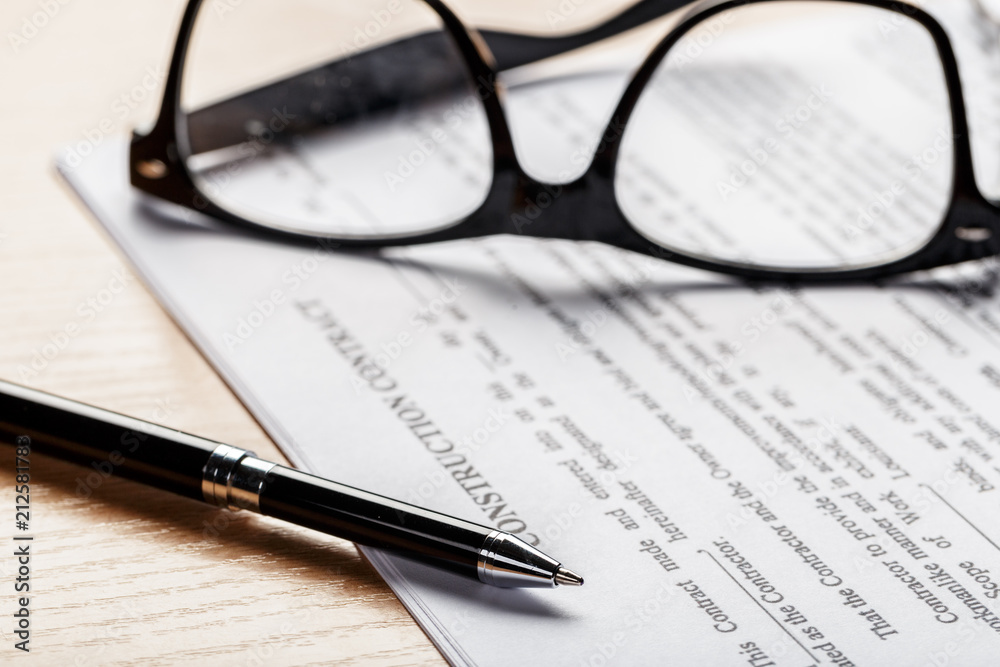Close up shot of Eyeglasses on document papers business concept Close up shot of Eyeglasses on document papers business concept