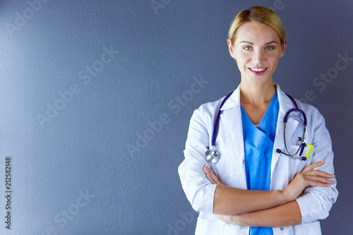 Fotografija Portrait of young woman doctor with white coat standing in hospital