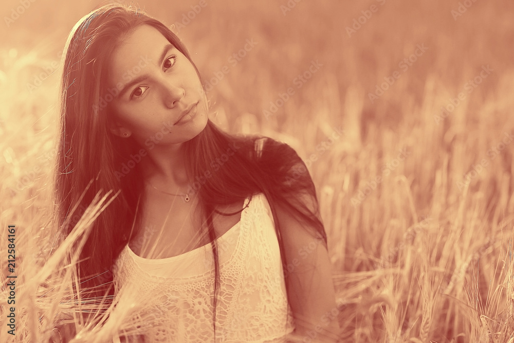 Young glamorous model posing in a field wheat Young glamorous model posing in a field wheat