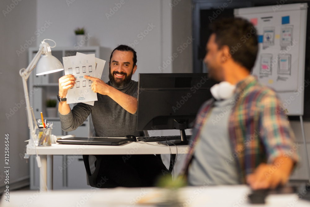 © Syda Productions - business, deadline and web design people concept - happy creative man showing papers to colleague at night office © Syda Productions - business, deadline and web design people concept - happy creative man showing papers to colleague at night office