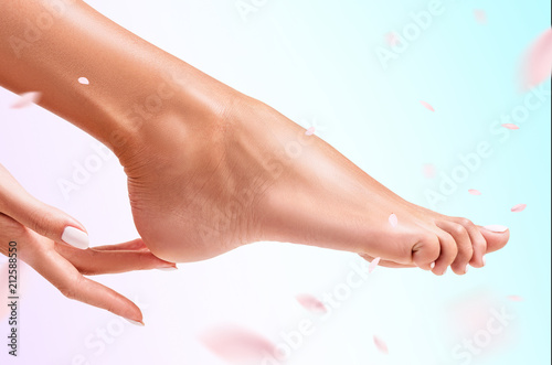Woman touches her feet.