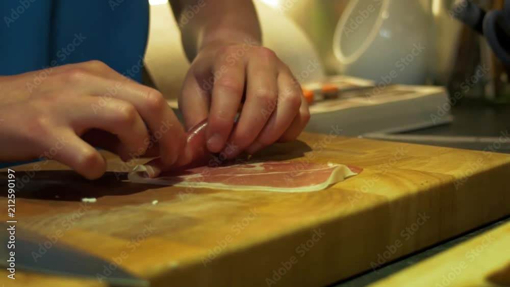 Rolling Serrano Ham up and placing it in a pot Rolling Serrano Ham up and placing it in a pot