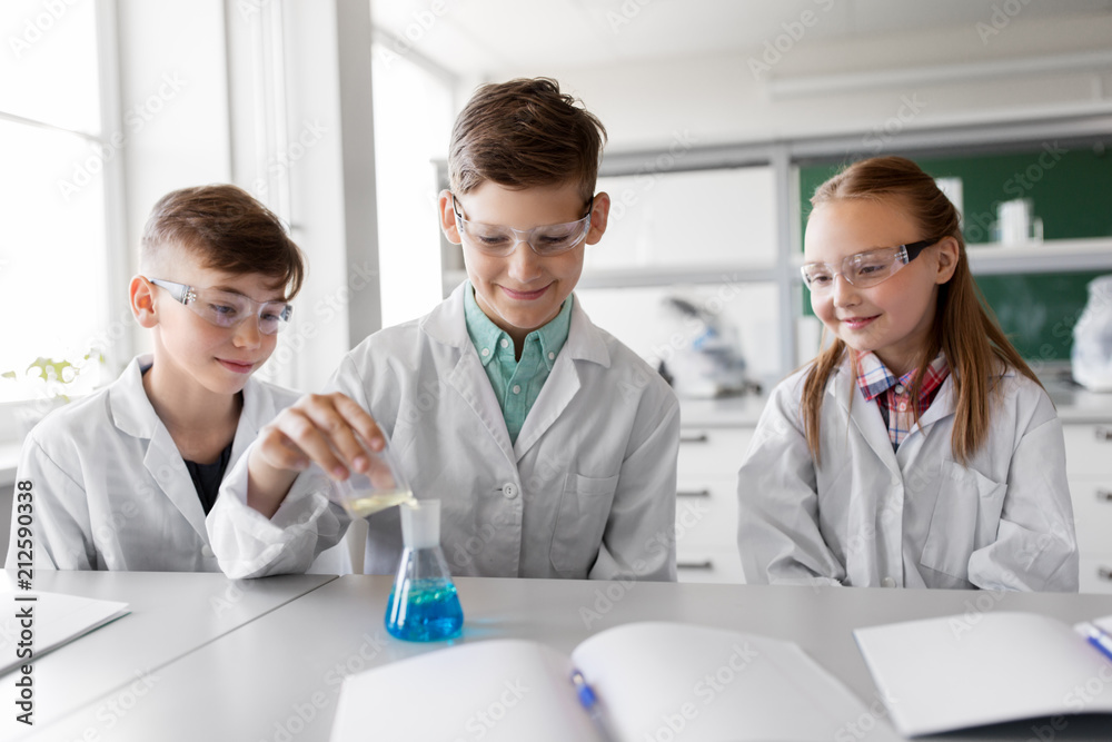 education, science, chemistry and children concept - kids or students with test tube making experiment at school laboratory education, science, chemistry and children concept - kids or students with test tube making experiment at school laboratory