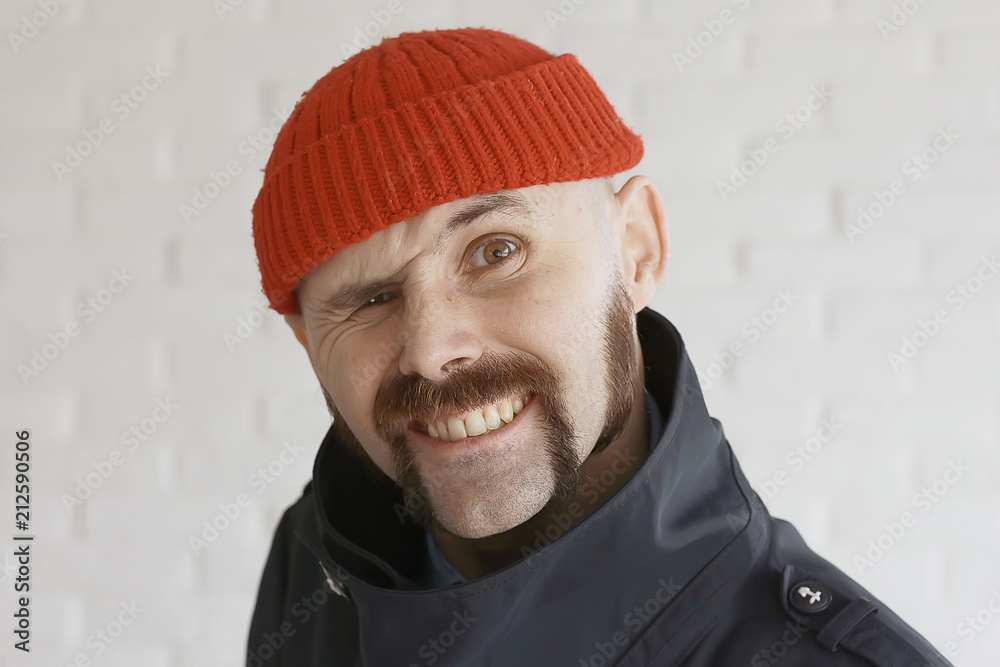 guy with a mustache in a red knitted hat guy with a mustache in a red knitted hat