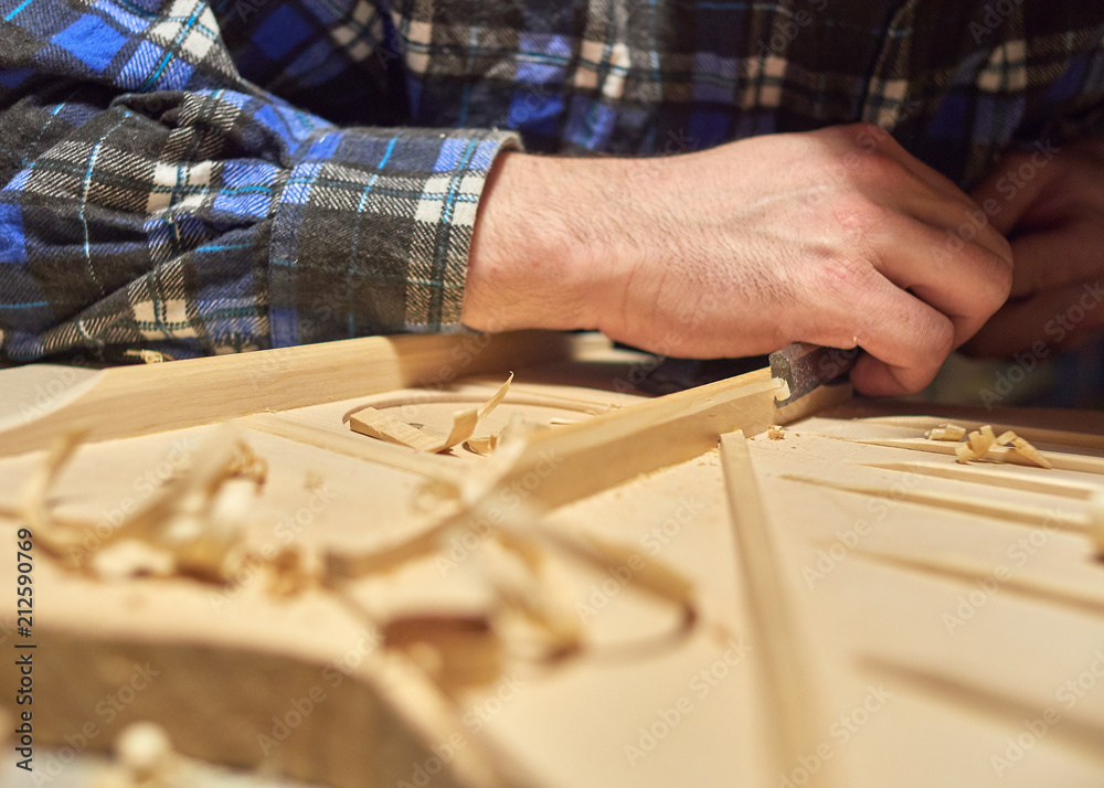 The process of making a classical guitar. Making the right shape of a brace guitar. The process of making a classical guitar. Making the right shape of a brace guitar.