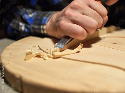 The process of making a classical guitar. Making the right shape of a brace guitar.