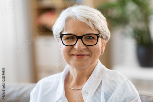 vision, age and people concept - portrait of happy senior woman in glasses