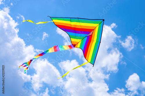 colorful flying kite flying in the sky with clouds photo