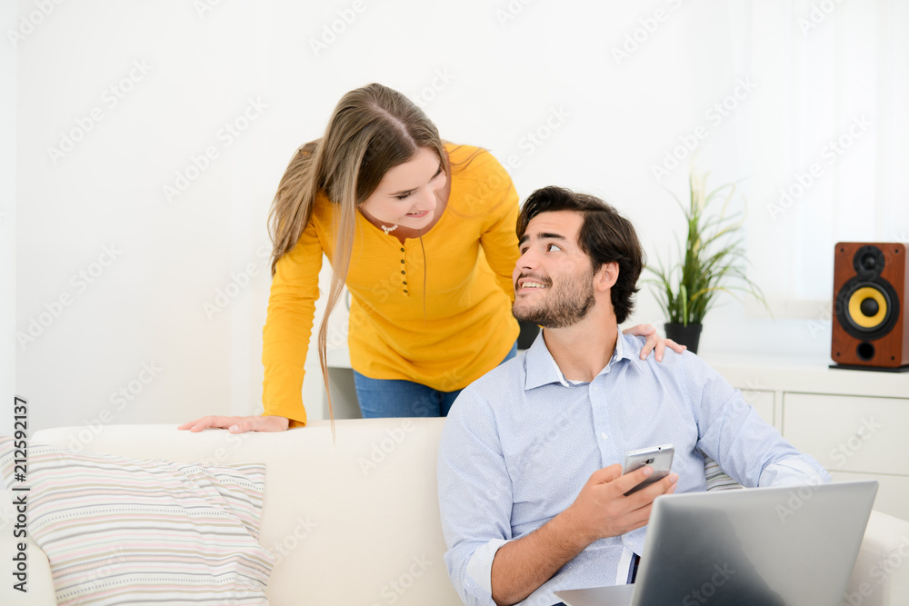 cheerful young couple on sofa at home websurfing and shopping online with laptop computer internet technology cheerful young couple on sofa at home websurfing and shopping online with laptop computer internet technology