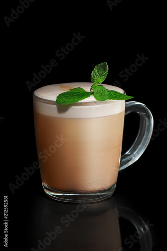 Transparent cup of mint Cappuccino isolated on black photo