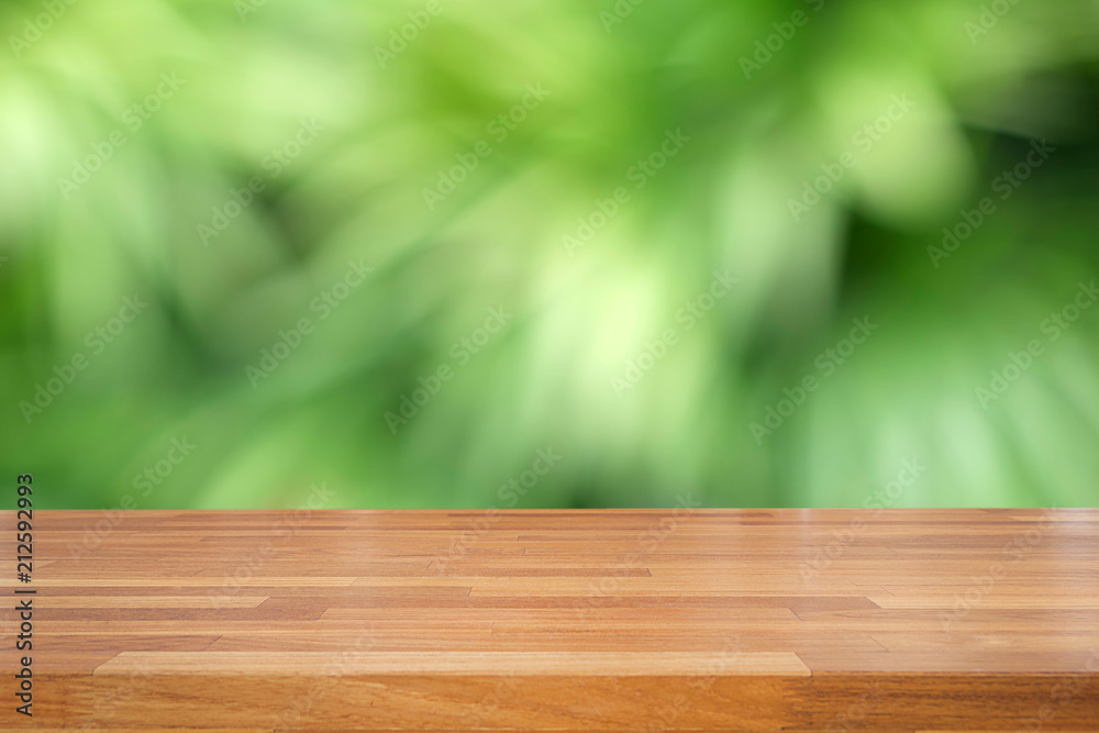 Empty wooden table and blurred green leaves background, product display, Ready for product montage. nature garden scene Empty wooden table and blurred green leaves background, product display, Ready for product montage. nature garden scene