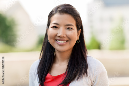 people concept - portrait of happy smiling asian woman outdoors