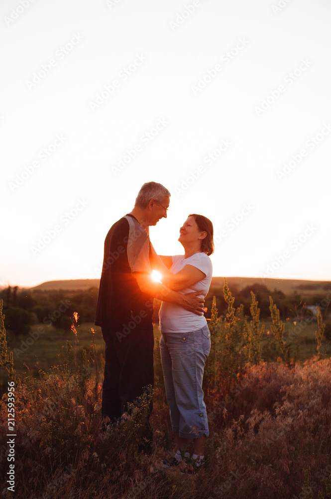 Couple holding hands at sunset enjoying romance and sun. Couple holding hands at sunset enjoying romance and sun.