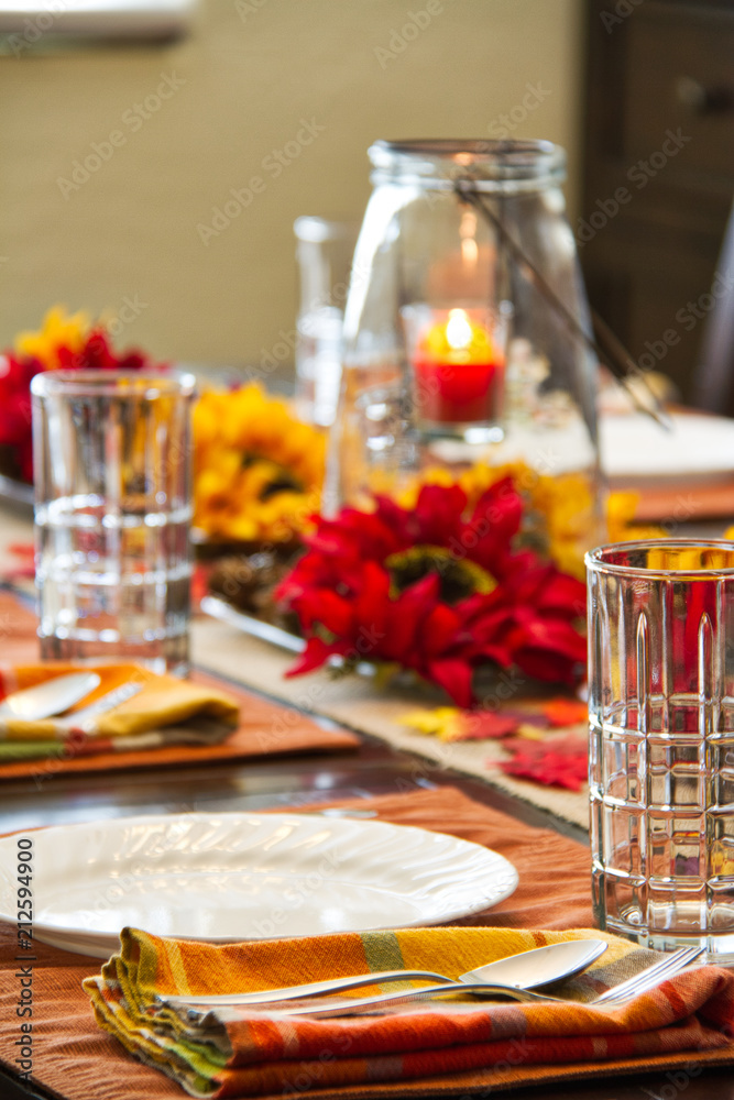 A table set for a fall feast with the focus on the foreground.