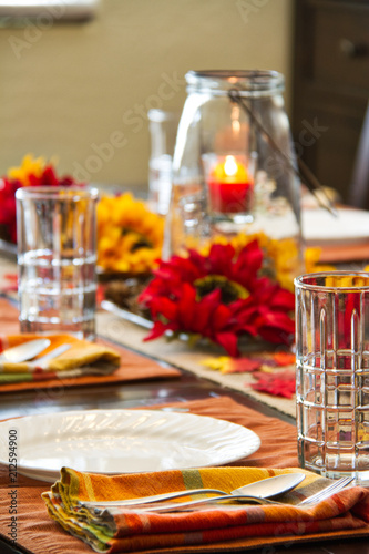 A table set for a fall feast with the focus on the foreground.