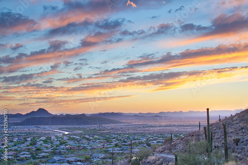 A hiking trail on the side of a mountain heading into an Arizona sunset. photo