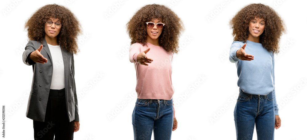 African american young woman wearing different outfits smiling friendly offering handshake as greeting and welcoming. Successful business. African american young woman wearing different outfits smiling friendly offering handshake as greeting and welcoming. Successful business.