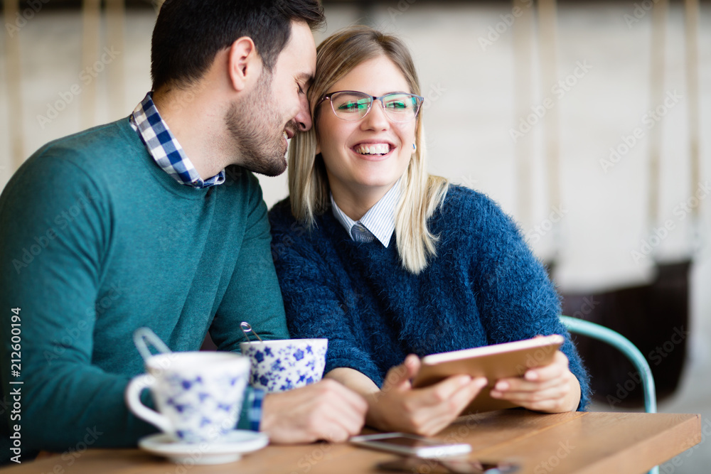 Young attractive couple on date in coffee shop