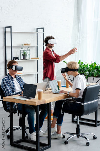 young people using virtual reality headsets while working together