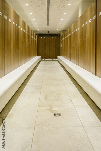 Modern Storage lockers in a swimming pool with bench , and led lighting.