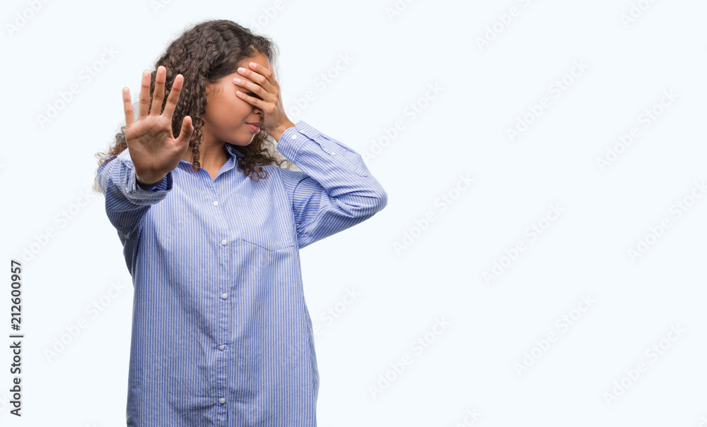 Young hispanic business woman covering eyes with hands and doing stop gesture with sad and fear expression. Embarrassed and negative concept. Young hispanic business woman covering eyes with hands and doing stop gesture with sad and fear expression. Embarrassed and negative concept.