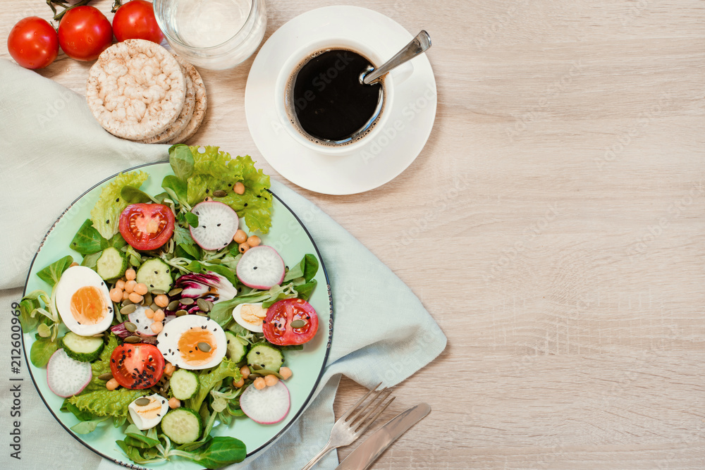 Fresh salad with vegetables and eggs for proper nutrition. Summer breakfast. Top view, copy space. Fresh salad with vegetables and eggs for proper nutrition. Summer breakfast. Top view, copy space.