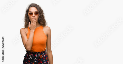 Young hispanic woman wearing summer outfit cover mouth with hand shocked with shame for mistake, expression of fear, scared in silence, secret concept