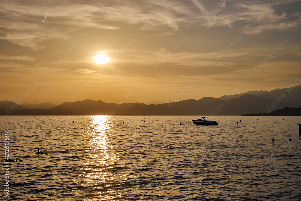 Spectacular sunset with beautiful light at City of Bardolino / Lake Garda in Italy