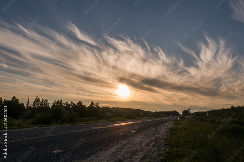 Beautiful clouds at sunset, warm summer evening Beautiful clouds at sunset, warm summer evening