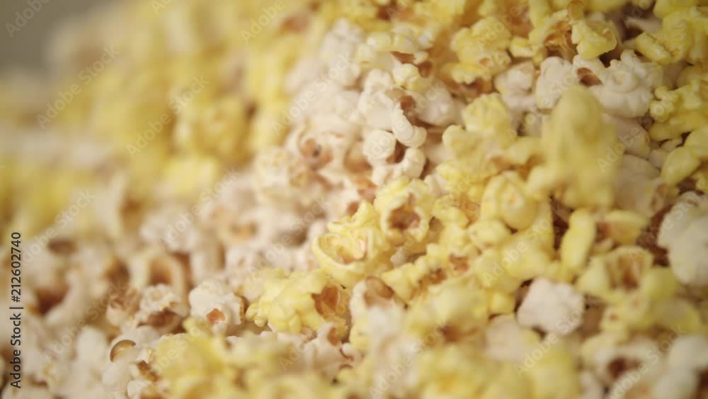 Ready popcorn falling in popcorn machine. Popcorn production process