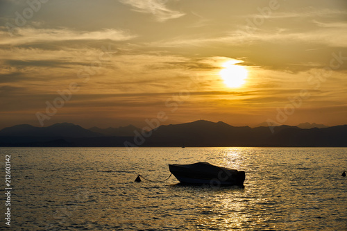 Spectacular sunset with beautiful light at City of Bardolino / Lake Garda in Italy