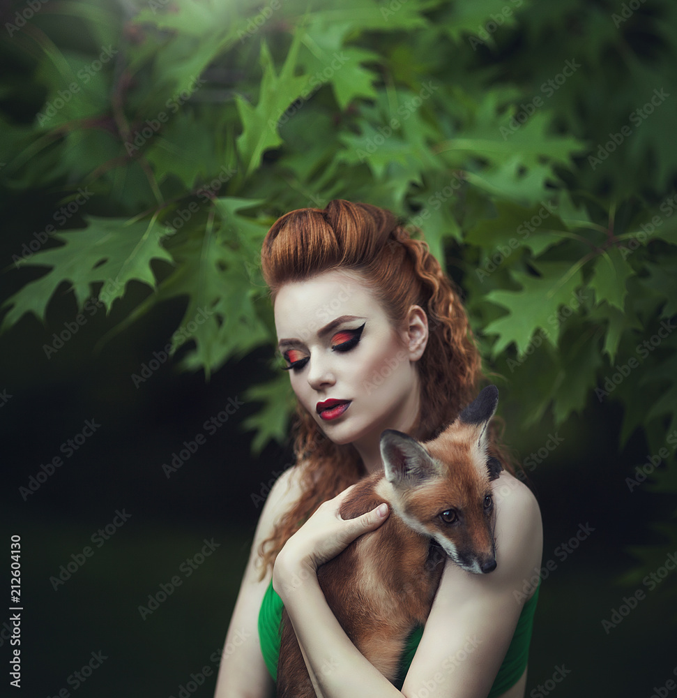 Portrait of a sensual red-haired girl in a green dress with a fox in a  fairy forest. Beautiful young woman with a young fox. Stock-Foto | Adobe  Stock