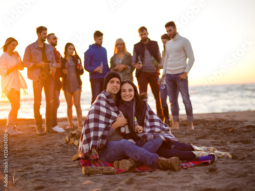 Couple enjoying with friends at sunset on the beach © .shock
