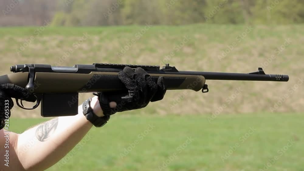 Panorama view of a man with double-barreled rifle. The man in glasses targets with a rifle Panorama view of a man with double-barreled rifle. The man in glasses targets with a rifle