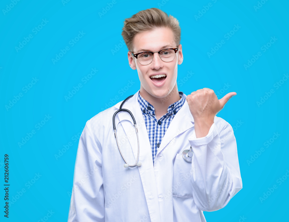Young handsome blond doctor pointing with hand and finger up with happy face smiling Young handsome blond doctor pointing with hand and finger up with happy face smiling