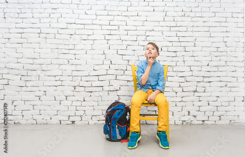 Schoolboy thinking hard about a problem being completely absorbed