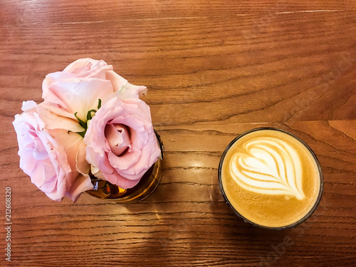 flowers and coffee on the wooden table