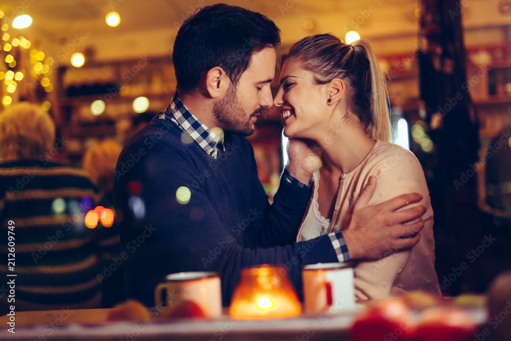 Romantic couple dating in pub at night Romantic couple dating in pub at night