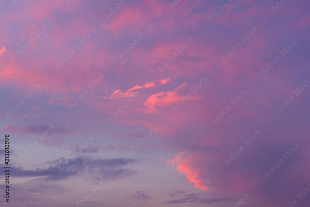 Dramatic fiery sunset sky in a mixture of violet, pink, orange and black colors