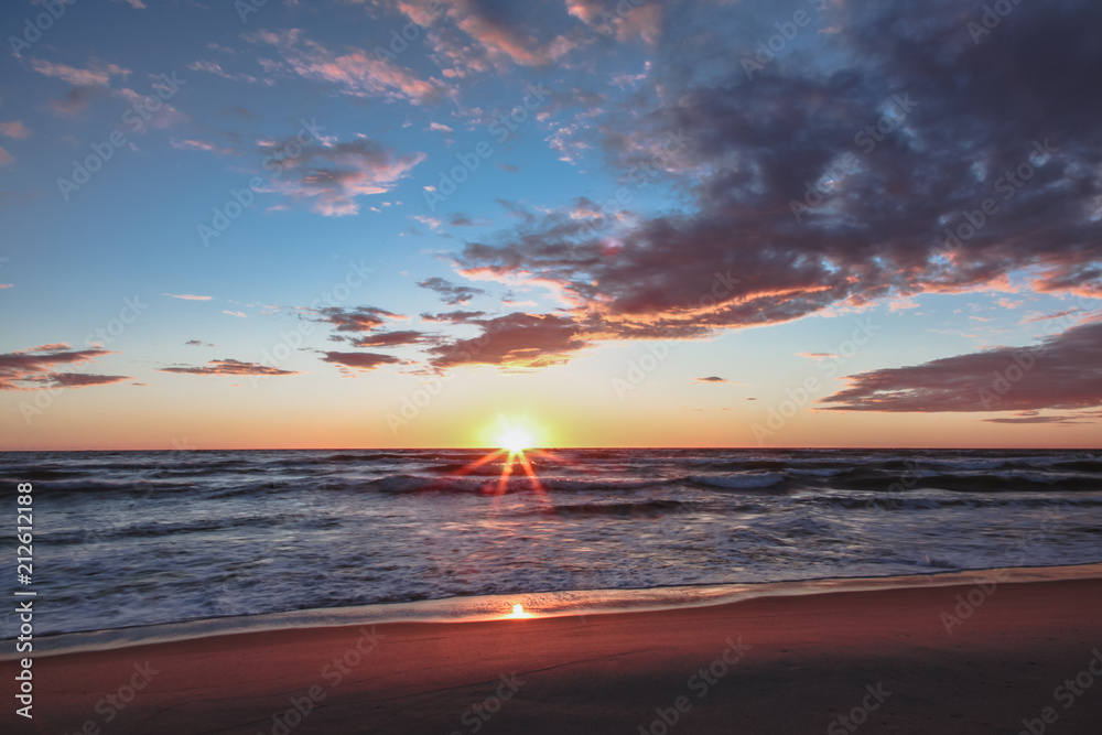 summer sunset at sea, sea waves, sun rays, dramatic sky, beautiful colors