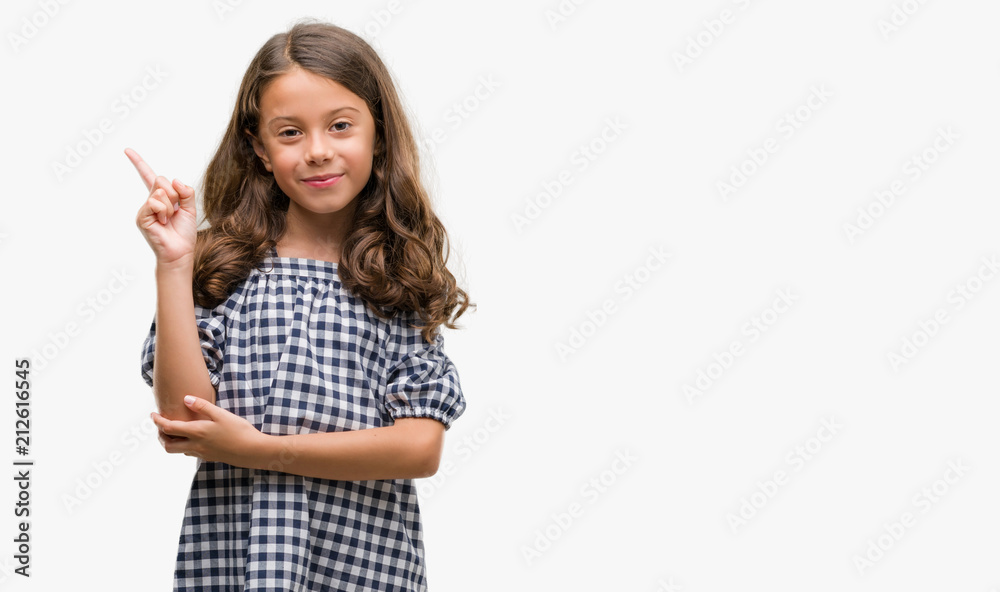 Brunette hispanic girl wearing black and white dress very happy pointing with hand and finger to the side Brunette hispanic girl wearing black and white dress very happy pointing with hand and finger to the side