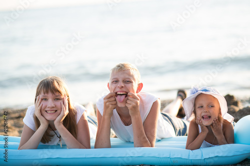 Three children on the beach © Evgenia Tiplyashina