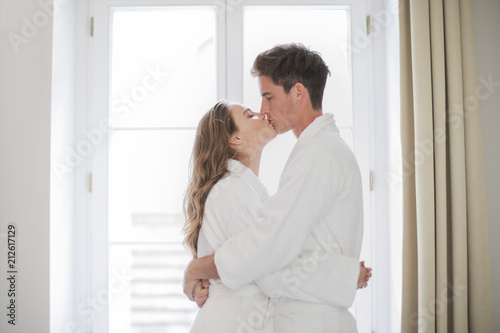 Happy couple kissing in a hotel room